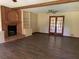 Spacious living room with a brick fireplace, wood floors, and french doors at 2751 Herron Cir, Snellville, GA 30039