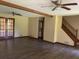 Open-concept living room featuring wood floors, exposed beams, and stairs to upper level at 2751 Herron Cir, Snellville, GA 30039