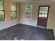 Versatile room with wood-look flooring, multiple windows, and a door leading to a deck at 2751 Herron Cir, Snellville, GA 30039