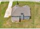 Drone image of a grey house with a covered patio and a chimney with a green yard at 149 Elkins Blvd, Locust Grove, GA 30248