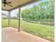 Covered back patio with a ceiling fan overlooks a spacious backyard with a privacy fence at 149 Elkins Blvd, Locust Grove, GA 30248