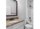 Bathroom featuring granite countertop, white cabinetry, and a shower-tub combo at 149 Elkins Blvd, Locust Grove, GA 30248