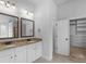 Primary bathroom with granite countertops, dual sinks and a walk in closet at 149 Elkins Blvd, Locust Grove, GA 30248