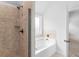 Bathroom featuring tiled shower, soaking tub and access to the bedroom at 149 Elkins Blvd, Locust Grove, GA 30248