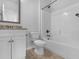 Bathroom with white cabinets, granite countertops, and a shower-tub combo at 149 Elkins Blvd, Locust Grove, GA 30248