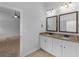 Bathroom featuring dual sinks, granite countertops, framed mirrors and modern lighting at 149 Elkins Blvd, Locust Grove, GA 30248