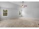 Spacious bedroom features neutral carpeting, ceiling fan, and bright windows at 149 Elkins Blvd, Locust Grove, GA 30248