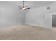 Large carpeted bedroom offering natural light, fan, and ensuite bathroom at 149 Elkins Blvd, Locust Grove, GA 30248