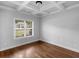 Well-lit bedroom with hardwood floors, a stylish ceiling light, and large window at 149 Elkins Blvd, Locust Grove, GA 30248