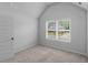 Bedroom features neutral carpet, a bright window, and white paint at 149 Elkins Blvd, Locust Grove, GA 30248