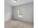 Neutral bedroom features carpet, a window with blinds, and ample natural light at 149 Elkins Blvd, Locust Grove, GA 30248