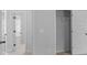 View of a bedroom with closet and door, painted with light gray color at 149 Elkins Blvd, Locust Grove, GA 30248
