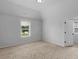 Bright bedroom with neutral carpeting, window, and white trim at 149 Elkins Blvd, Locust Grove, GA 30248
