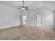 Large carpeted bedroom offering natural light, fan, and ensuite bathroom at 149 Elkins Blvd, Locust Grove, GA 30248
