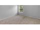 A bright bedroom with neutral carpet and window offering outdoor views at 149 Elkins Blvd, Locust Grove, GA 30248