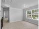 The bonus room has neutral carpet, a bright window, and an open doorway at 149 Elkins Blvd, Locust Grove, GA 30248