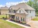 Charming two-story home with brick and siding, attached two-car garage, and landscaped yard at 149 Elkins Blvd, Locust Grove, GA 30248