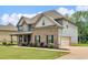 Charming two-story home with brick and siding, plus a manicured lawn at 149 Elkins Blvd, Locust Grove, GA 30248