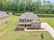 Charming two-story home with brick and siding, set on a well-maintained lawn with mature trees at 149 Elkins Blvd, Locust Grove, GA 30248