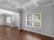 Bright entry area with beautiful hardwood floors, a decorative ceiling, and large windows at 149 Elkins Blvd, Locust Grove, GA 30248