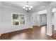 Light-filled foyer with hardwood floors, wainscoting and entry to adjacent dining room at 149 Elkins Blvd, Locust Grove, GA 30248