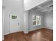 Bright foyer featuring hardwood floors, high ceilings, and a classic white front door at 149 Elkins Blvd, Locust Grove, GA 30248
