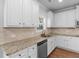 Well-lit kitchen featuring granite counters, stainless steel appliances, and white cabinets at 149 Elkins Blvd, Locust Grove, GA 30248