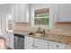 Kitchen features granite countertops, stainless steel appliances and white cabinets at 149 Elkins Blvd, Locust Grove, GA 30248
