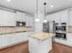 Modern kitchen boasts granite countertops, stainless appliances, and a central island at 149 Elkins Blvd, Locust Grove, GA 30248