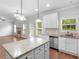 Open concept kitchen with island, granite countertops and stainless steel appliances at 149 Elkins Blvd, Locust Grove, GA 30248