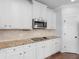 Kitchen features stainless steel appliances, granite countertops and white cabinets at 149 Elkins Blvd, Locust Grove, GA 30248
