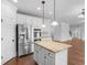 Kitchen with stainless steel appliances, granite countertops, and central island at 149 Elkins Blvd, Locust Grove, GA 30248