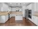 Modern kitchen with stainless steel appliances, island, granite counters, and hardwood floors at 149 Elkins Blvd, Locust Grove, GA 30248