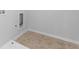 This functional laundry area features neutral tile flooring and utility connections at 149 Elkins Blvd, Locust Grove, GA 30248