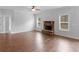 Spacious living room features a stone fireplace and natural light from the large windows at 149 Elkins Blvd, Locust Grove, GA 30248