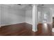 Bright living room with dark hardwood floors, coffered ceiling, columns, and neutral walls at 149 Elkins Blvd, Locust Grove, GA 30248