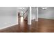 Open-concept living space with hardwood floors, elegant columns, and a cozy fireplace at 149 Elkins Blvd, Locust Grove, GA 30248