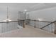 Loft area with carpet, decorative chandelier, and wrought iron railing at 149 Elkins Blvd, Locust Grove, GA 30248