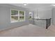 Carpeted loft space with wrought iron railing, large window, and recessed lighting at 149 Elkins Blvd, Locust Grove, GA 30248