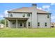 View of the rear exterior of a two story home with a covered patio and green lawn at 149 Elkins Blvd, Locust Grove, GA 30248