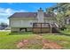 View of the back of the house with a deck and steps down to the backyard at 11739 Sawgrass Ct, Fayetteville, GA 30215