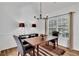 Cozy dining room featuring a modern light fixture, neutral tones, and ample natural light at 11739 Sawgrass Ct, Fayetteville, GA 30215