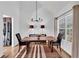 Elegant dining room with modern chandelier and views to living room and kitchen at 11739 Sawgrass Ct, Fayetteville, GA 30215