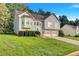Beautiful suburban home with lush green lawn and lovely landscaping on a sunny day at 11739 Sawgrass Ct, Fayetteville, GA 30215