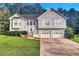 Charming two-story traditional home with a well-manicured lawn and a two-car garage at 11739 Sawgrass Ct, Fayetteville, GA 30215