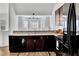 Modern kitchen showcasing dark wood cabinets, black appliances, and natural light at 11739 Sawgrass Ct, Fayetteville, GA 30215
