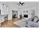 Bright living room with a fireplace, modern furniture, and stylish pendant lighting at 11739 Sawgrass Ct, Fayetteville, GA 30215