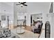 Spacious and bright living room with fireplace and stylish decor and views to the entry and kitchen at 11739 Sawgrass Ct, Fayetteville, GA 30215