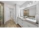 A luxurious bathroom featuring double sinks, a bathtub, and a glass-enclosed shower at 1618 Durden Ne Rd, Atlanta, GA 30319
