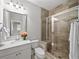 Well-lit bathroom featuring a glass-enclosed shower, granite vanity, and modern fixtures at 1618 Durden Ne Rd, Atlanta, GA 30319